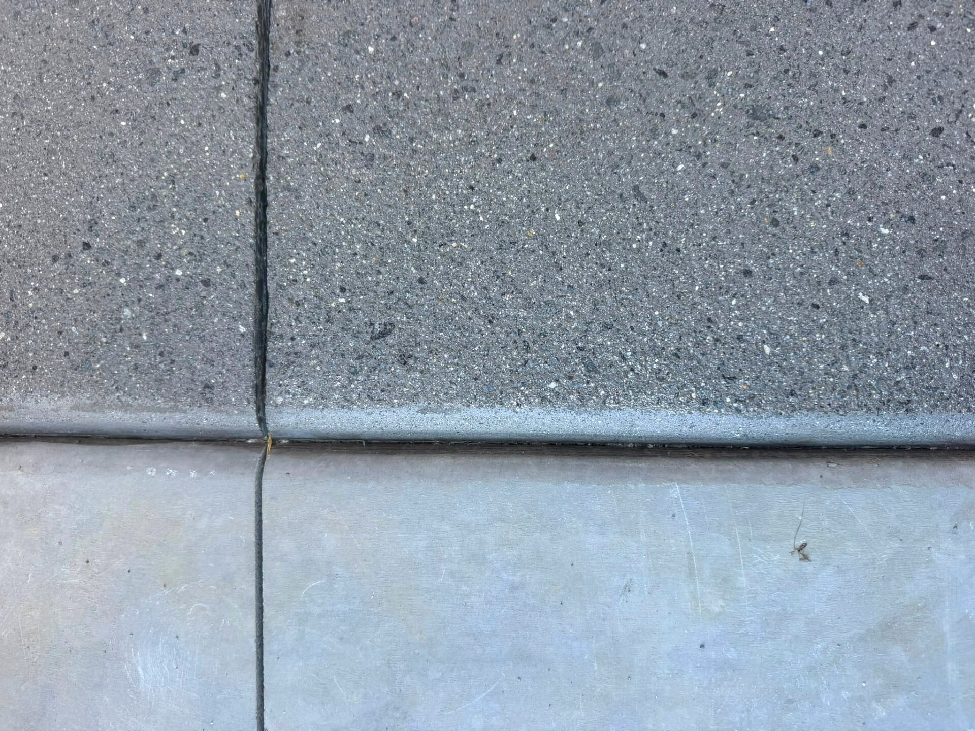 Macro view of a ground concrete surface showing aggregate and cement matrix